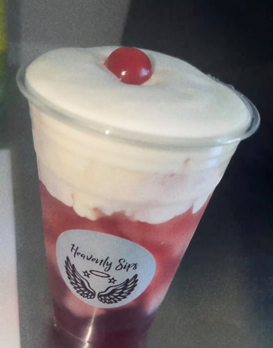 A cherry cream soda with cold foam and a cherry on top