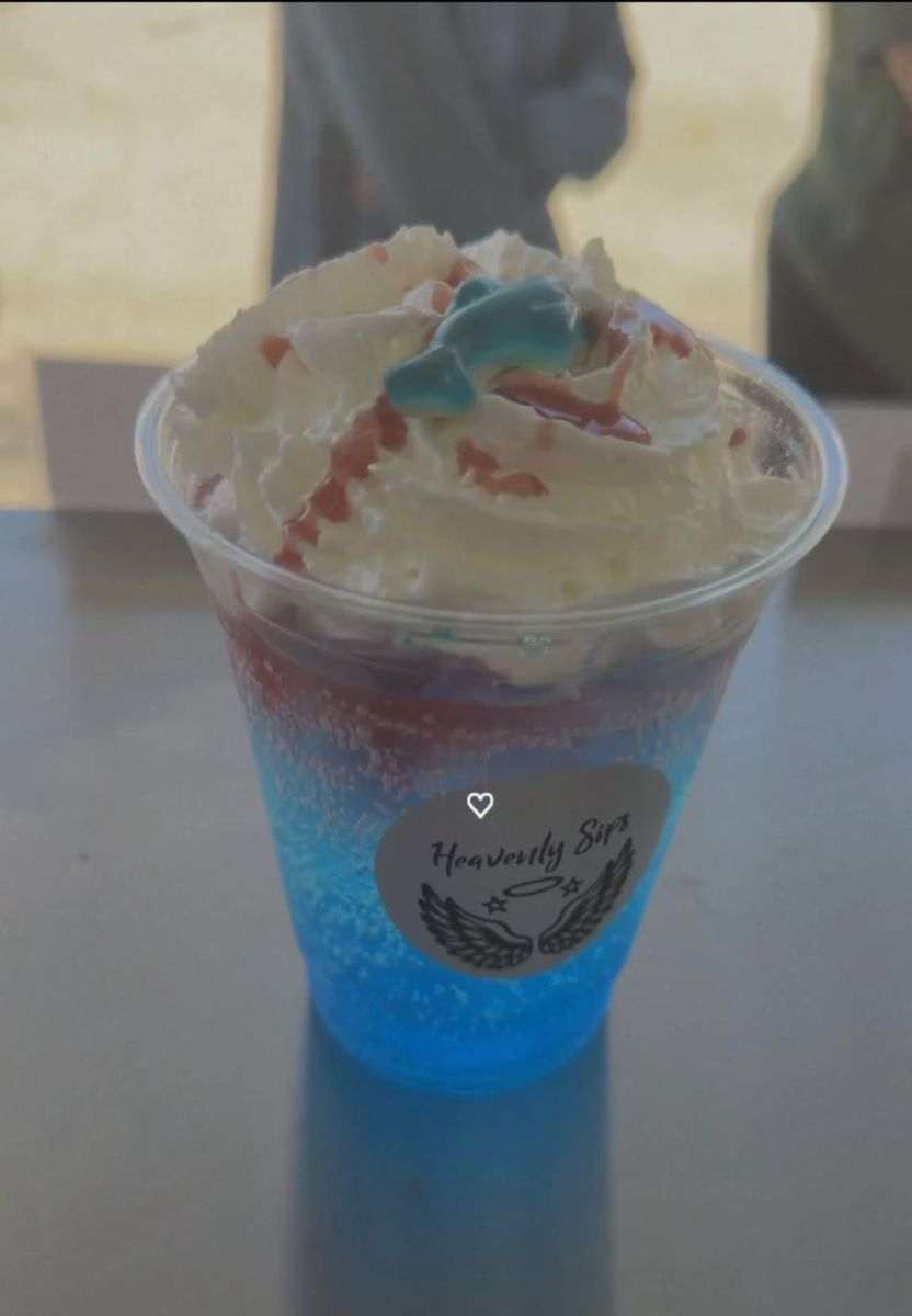 Shark Attack dirty soda with whipped cream and a gummy shark